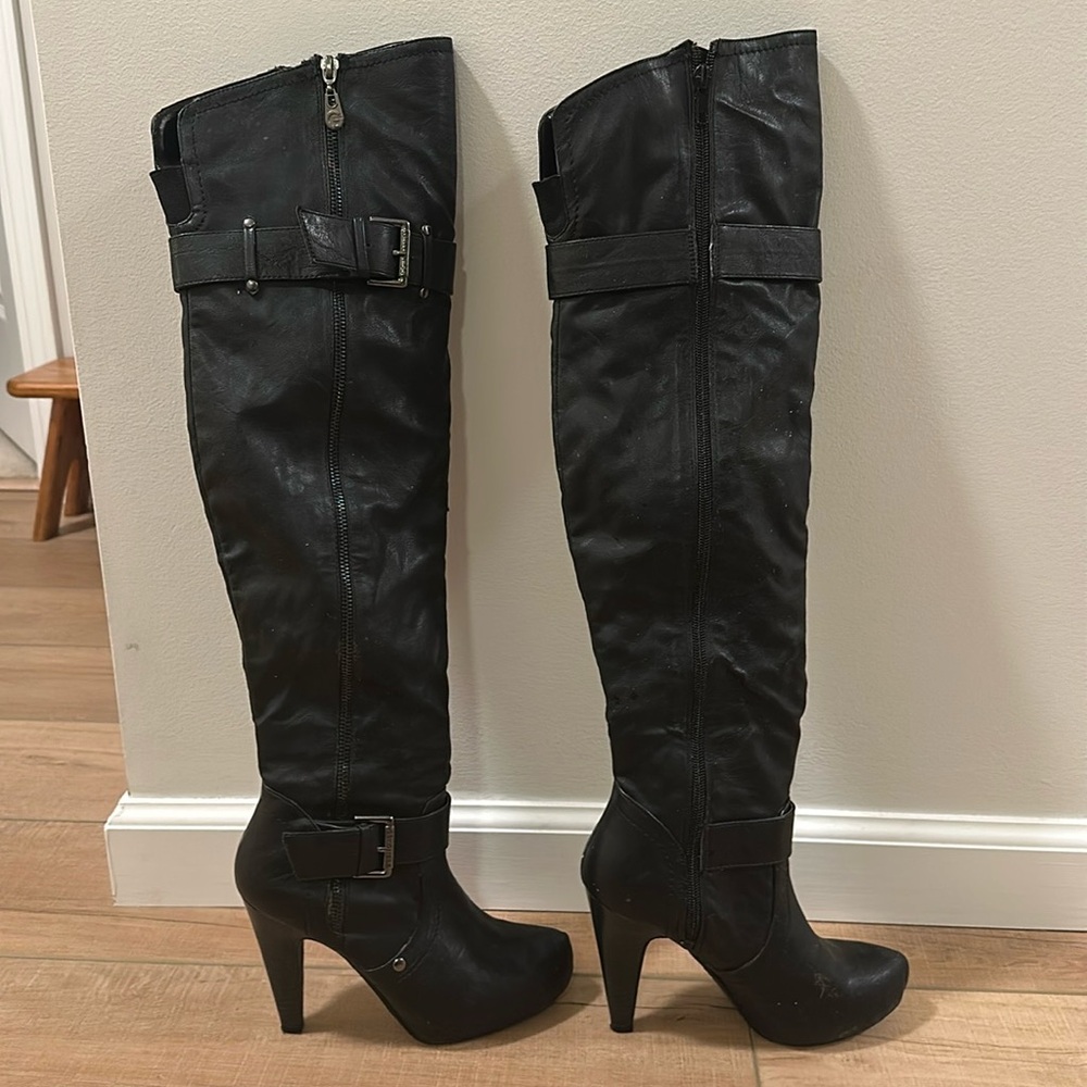 Tall, over the knee heeled boots. 4” heels